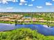 Aerial view showcasing a lakefront home in a desirable community at 20686 Valprato Ct, Venice, FL 34293