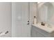 Bright bathroom features a vanity with a round mirror and sleek fixtures at 20686 Valprato Ct, Venice, FL 34293