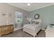 Comfortable bedroom with wood floors, coastal decor, and plenty of natural light at 20686 Valprato Ct, Venice, FL 34293