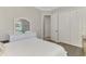 Comfortable bedroom featuring a built-in closet, wood floors, and neutral paint at 20686 Valprato Ct, Venice, FL 34293
