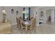 Cozy dining room with neutral walls, crown molding, and stylish furniture at 20686 Valprato Ct, Venice, FL 34293