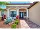 Inviting front entryway with decorative plants, brick walkway and leaded glass door at 20686 Valprato Ct, Venice, FL 34293