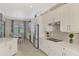 Spacious kitchen with stainless steel appliances, custom cabinetry, tile backsplash and a dining area at 20686 Valprato Ct, Venice, FL 34293