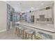 Bright and airy kitchen with a large island, pendant lighting, and modern appliances at 20686 Valprato Ct, Venice, FL 34293