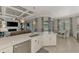 Open floor plan with island connecting the kitchen, dining area, and living space with backyard views at 20686 Valprato Ct, Venice, FL 34293