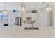 A modern kitchen with stainless steel appliances, a large center island, and white cabinetry at 20686 Valprato Ct, Venice, FL 34293