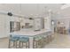 Bright, open kitchen featuring pendant lighting, an island with seating, and stainless appliances at 20686 Valprato Ct, Venice, FL 34293