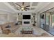 Comfortable living room with a large ceiling fan and a custom-built entertainment center at 20686 Valprato Ct, Venice, FL 34293