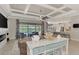 Open-concept living room featuring coffered ceilings and sliding glass doors to the outdoor pool at 20686 Valprato Ct, Venice, FL 34293