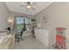 Well-lit home office featuring a large window, neutral color palette, and functional layout at 20686 Valprato Ct, Venice, FL 34293
