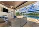 Covered patio with comfortable seating and fireplace at 20686 Valprato Ct, Venice, FL 34293