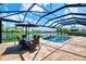 Screened pool and patio furniture with lake view at 20686 Valprato Ct, Venice, FL 34293