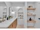 Spa-like bathroom with double vanity, unique shelving, and modern fixtures at 2226 Arlington St, Sarasota, FL 34239