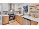 Modern kitchen with stainless steel appliances and light wood cabinets at 2226 Arlington St, Sarasota, FL 34239