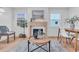 Living room with a modern fireplace, hardwood floors, and a dining area at 2226 Arlington St, Sarasota, FL 34239