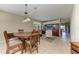 Round dining table with six chairs, view of living room at 234 River Enclave Ct, Bradenton, FL 34212