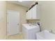 Laundry room with washer, dryer, and cabinets at 234 River Enclave Ct, Bradenton, FL 34212