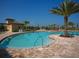 Freeform community pool with a spacious deck and lounge chairs at 234 River Enclave Ct, Bradenton, FL 34212