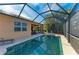 Inviting pool area with screened enclosure, comfortable lounge chairs, and lush landscaping at 234 River Enclave Ct, Bradenton, FL 34212
