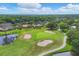 Aerial view of a golf course with lush greenery and a pond at 2421 Crispin Ct # E3, Sarasota, FL 34235