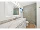 Bright bathroom with marble vanity and geometric tile shower at 2421 Crispin Ct # E3, Sarasota, FL 34235