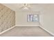 Bedroom with patterned wallpaper and ceiling fan at 2421 Crispin Ct # E3, Sarasota, FL 34235
