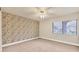Bedroom with patterned wallpaper and ceiling fan at 2421 Crispin Ct # E3, Sarasota, FL 34235
