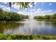 Serene community lake with a central fountain at 2421 Crispin Ct # E3, Sarasota, FL 34235