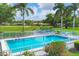 Community pool with patio furniture and lush landscaping at 2421 Crispin Ct # E3, Sarasota, FL 34235