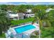 Community pool with surrounding patio and lush landscaping at 2421 Crispin Ct # E3, Sarasota, FL 34235