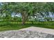 Backyard with stone patio and large shade tree at 2534 Stagnaro Rd, North Port, FL 34287