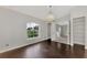 Spacious bedroom with large window and dark wood floors at 2534 Stagnaro Rd, North Port, FL 34287