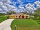 House exterior with a large front yard and driveway at 2534 Stagnaro Rd, North Port, FL 34287