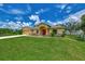 Single-story home with attached garage and spacious lawn at 2534 Stagnaro Rd, North Port, FL 34287