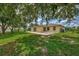 House exterior showcasing a large backyard and tree at 2534 Stagnaro Rd, North Port, FL 34287