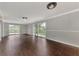 Sunlit Gathering room with sliding doors and dark wood flooring at 2534 Stagnaro Rd, North Port, FL 34287