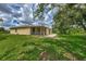 House exterior with a screened porch and landscaped yard at 2534 Stagnaro Rd, North Port, FL 34287