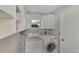 Laundry room with washer, dryer, and ample shelving at 2534 Stagnaro Rd, North Port, FL 34287