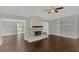 Living room with fireplace and dark brown tile floors at 2534 Stagnaro Rd, North Port, FL 34287