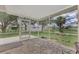 Screened porch with flagstone flooring and backyard view at 2534 Stagnaro Rd, North Port, FL 34287
