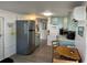 Bright kitchen with stainless steel refrigerator and light teal cabinets at 2601 Gulf N Dr # 729, Bradenton Beach, FL 34217