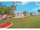 Mobile home community with green lawns and palm trees at 283 Bainbridge Dr, Nokomis, FL 34275