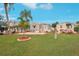 Mobile home community showcasing a gray home with a yard at 283 Bainbridge Dr, Nokomis, FL 34275
