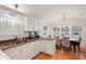 Modern kitchen with white cabinets, granite countertops, and a double sink at 283 Bainbridge Dr, Nokomis, FL 34275