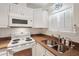 Clean kitchen, white cabinets, granite countertop, and a double sink at 283 Bainbridge Dr, Nokomis, FL 34275
