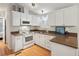 Bright kitchen features white cabinets, granite countertops, and modern appliances at 283 Bainbridge Dr, Nokomis, FL 34275