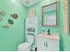 Small bathroom with teal walls and white vanity at 305 Pameto Rd, Nokomis, FL 34275