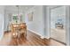 Light-filled dining area, hardwood floors, and view to another room at 305 Pameto Rd, Nokomis, FL 34275