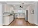 Modern kitchen with white cabinets, granite counters, and stainless steel appliances at 305 Pameto Rd, Nokomis, FL 34275