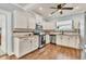 Modern kitchen with white cabinets, granite counters, and stainless steel appliances at 305 Pameto Rd, Nokomis, FL 34275